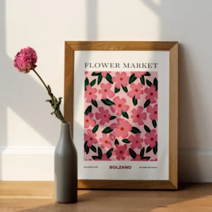 FlowerMarket Bolzano with wooden frame on wooden floor in front of a white wall and a pink flower